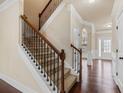 Carpeted staircase with stained wood handrail and decorative wrought iron spindles at 461 Summerstone Ln, Lawrenceville, GA 30044