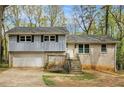 Charming split-level home with brick and siding, garage, and inviting front steps at 626 Mincey Ct, Stone Mountain, GA 30087