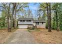 Attractive split-level home with siding, brick accents, and a spacious driveway at 626 Mincey Ct, Stone Mountain, GA 30087