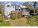 Image showcases a tiered deck overlooking a beautifully landscaped backyard at 10845 Shallowford Rd, Roswell, GA 30075