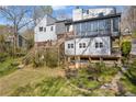View of the backyard with a deck and stairs leading to the lush greenery at 10845 Shallowford Rd, Roswell, GA 30075