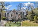 Charming two-story home with attractive landscaping and unique architectural details at 10845 Shallowford Rd, Roswell, GA 30075