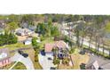 Bird's eye view of a beautiful home and its surroundings featuring a long driveway and mature trees at 2245 Friars Gate Dr, Lawrenceville, GA 30043