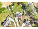 Aerial view of a spacious home with a sprawling yard, circular drive and mature trees in a suburban neighborhood at 2245 Friars Gate Dr, Lawrenceville, GA 30043