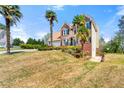 Charming brick home featuring lush landscaping and a two-car garage on a sunny day at 2245 Friars Gate Dr, Lawrenceville, GA 30043