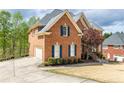 Spacious brick home with an attached garage, driveway, and well-maintained landscaping, providing both convenience and curb appeal at 4020 Balleycastle Ln, Duluth, GA 30097