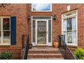 Welcoming front entrance featuring a decorative glass door, brick steps, and black wrought iron railings at 4020 Balleycastle Ln, Duluth, GA 30097