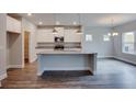 Modern kitchen with granite countertops, stainless steel appliances, and a spacious island at 4265 Easter Lily Ave, Buford, GA 30519