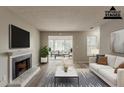 Virtually staged living room with fireplace, modern decor, and an open concept design at 104 Natchez Trce, Atlanta, GA 30350