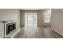 Bright living room with fireplace and view to screened porch with lots of natural light at 104 Natchez Trce, Atlanta, GA 30350