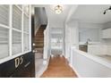 Inviting foyer with hardwood floors, staircase, and views of the kitchen and living area at 10900 Wittenridge Dr # D5, Alpharetta, GA 30022