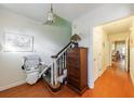 Bright entryway featuring hardwood floors, a staircase with a stair lift, and access to other rooms in the home at 272 Windsor Pkwy, Atlanta, GA 30342
