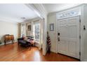 Inviting foyer with hardwood floors, natural light streaming through the windows, and a charming side sitting area at 272 Windsor Pkwy, Atlanta, GA 30342