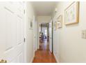 Hallway with hardwood floors and white doors leading to various rooms, offering a glimpse into the home's layout at 272 Windsor Pkwy, Atlanta, GA 30342