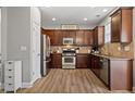 Well-equipped kitchen with stainless steel appliances, wooden cabinets and ample counter space at 3806 Carriage House Dr, Cumming, GA 30040