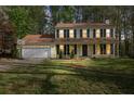 Charming two-story home with a welcoming front porch and well-maintained lawn at twilight at 925 Crab Orchard Dr, Roswell, GA 30076