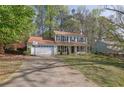 Charming two-story home with a welcoming front porch and well-maintained lawn at 925 Crab Orchard Dr, Roswell, GA 30076