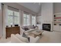 Bright living room featuring large windows, a fireplace, and neutral decor at 1658 Lightfoot Cir, Marietta, GA 30062