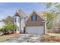Attractive exterior view of this two-story home with well-manicured lawn and a two-car garage at 1480 Bramlett Forest Se Trl, Lawrenceville, GA 30045