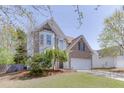 Lovely two-story home featuring a two-car garage, landscaped lawn, and inviting curb appeal at 1480 Bramlett Forest Se Trl, Lawrenceville, GA 30045