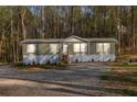 Charming single-story home with a lush, wooded backdrop and well-maintained front yard at 2466 Monroe Jersey Rd, Covington, GA 30014
