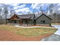 Charming exterior featuring a wooden frame porch and landscaped front yard at 313 Morgan Rd, Temple, GA 30179
