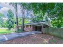 Lovely exterior view of brick home featuring an attached carport and mature trees at 3932 Lindsey Dr, Decatur, GA 30035