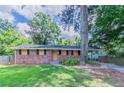 Traditional brick home with attached carport and well-maintained lawn at 3932 Lindsey Dr, Decatur, GA 30035