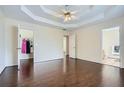 Spacious main bedroom with trey ceilings, dark hardwood floors, and access to the walk-in closet at 5997 Tate Dr, Austell, GA 30106