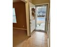 View of open front door with storm door and wreath at 709 Kilkenny Cir, Lithonia, GA 30058