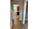 View of hallway with brown tile leading to the kitchen at 709 Kilkenny Cir, Lithonia, GA 30058