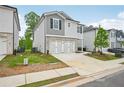 View of a new home exterior displaying siding, a two-car garage, driveway and landscaping on a sunny day at 2771 Aralynn Way, College Park, GA 30337