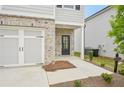 Exterior showcasing the brick facade, two-car garage, front entrance and landscaped yard at 2771 Aralynn Way, College Park, GA 30337