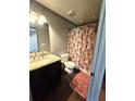 A bathroom with granite countertop vanity, decorative shower curtain, and dark stained cabinet at 300 Outlaw Rdg, Canton, GA 30115