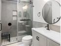 Modern bathroom featuring glass shower, updated vanity with round mirror, and stylish fixtures at 475 Mount Vernon Ne Hwy # 226C, Atlanta, GA 30328