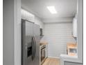 Modern kitchen with stainless steel refrigerator, wooden countertops, and white cabinets at 475 Mount Vernon Ne Hwy # 226C, Atlanta, GA 30328