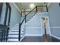 Inviting foyer showcasing staircase and hardwood floors, complemented by natural light at 1810 Talbot Ct, Lawrenceville, GA 30044