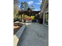 Stone patio with a pergola, swing, chairs, and outdoor furniture perfect for outdoor entertaining at 595 Willow Knoll Se Dr, Marietta, GA 30067