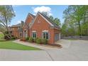 Beautiful brick home with manicured landscaping, attached garage, and a well-maintained driveway at 1025 Saint Marks Walk, Suwanee, GA 30024