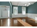 Bright living room with hardwood floors, coffered ceiling, and large windows with white trim at 1610 Apollo Dr, Suwanee, GA 30024