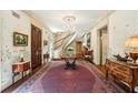 Elegant foyer with curved staircase, chandelier, and refined decor creating a grand entrance at 4195 Woodland Brook Se Dr, Atlanta, GA 30339
