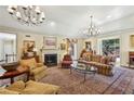 Sophisticated living room featuring a fireplace, chandeliers, and plush seating for elegant gatherings at 4195 Woodland Brook Se Dr, Atlanta, GA 30339