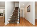 Elegant staircase with hardwood floors, a patterned runner, and white trim at 6795 Brandon Mill Rd, Atlanta, GA 30328
