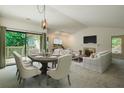 Bright living and dining room with vaulted ceiling, fireplace, and sliding door to deck at 202 Garden Ct, Atlanta, GA 30328
