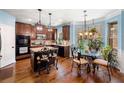 Open kitchen featuring an island with seating, wood cabinets, stainless steel appliances, and a bright breakfast nook at 251 Manous Way, Canton, GA 30115