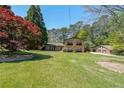 Expansive front yard of a brick home with mature trees and lush green lawn at 3530 Embry Cir, Atlanta, GA 30341