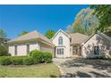 Charming stucco home with manicured landscaping, attached garage, and inviting stone accented entryway at 370 Royal Birkdale Ct, Johns Creek, GA 30097