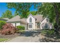 Well-maintained home with lush landscaping, manicured yard and driveway leading up to a charming stucco exterior at 370 Royal Birkdale Ct, Johns Creek, GA 30097