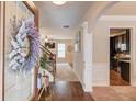 Open foyer showcasing hardwood floors, staircase, and views into the living room and kitchen at 5036 Maplecliff Dr, Sugar Hill, GA 30518
