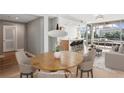 Staged open-concept living area with hardwood floors, stylish dining set, and modern kitchen with breakfast bar at 250 Park Avenue West Nw # 313, Atlanta, GA 30313